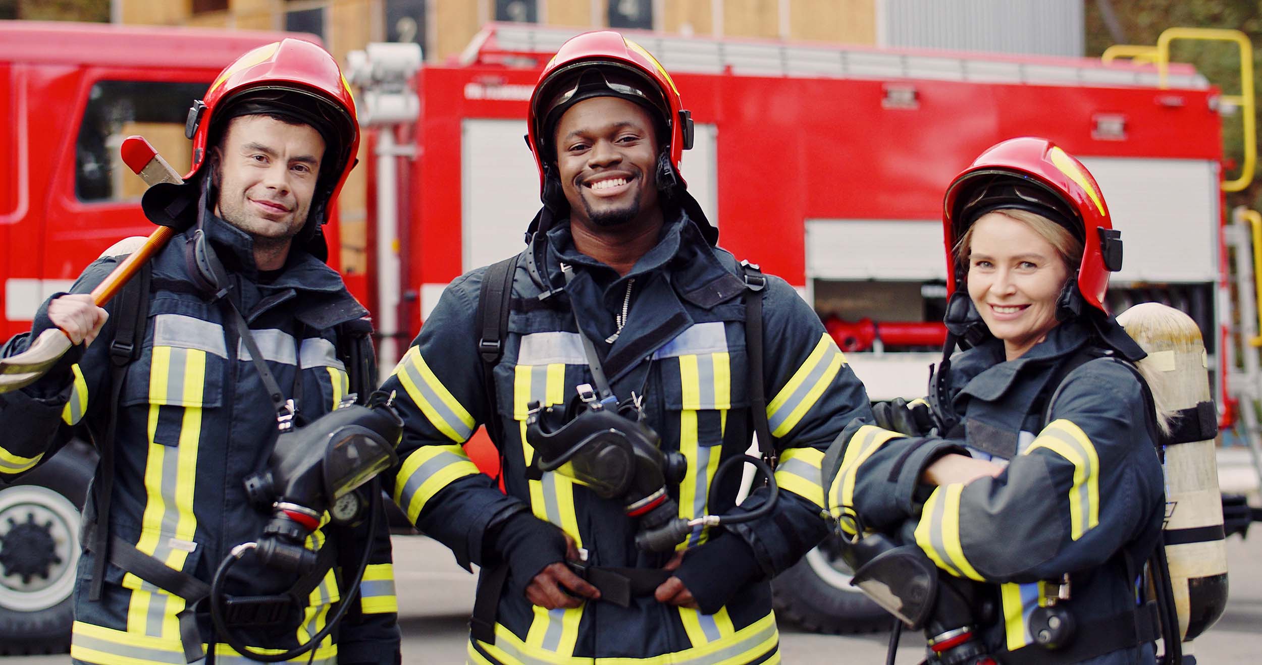 Portrait of group firefighters standing near fire truck. Firefig